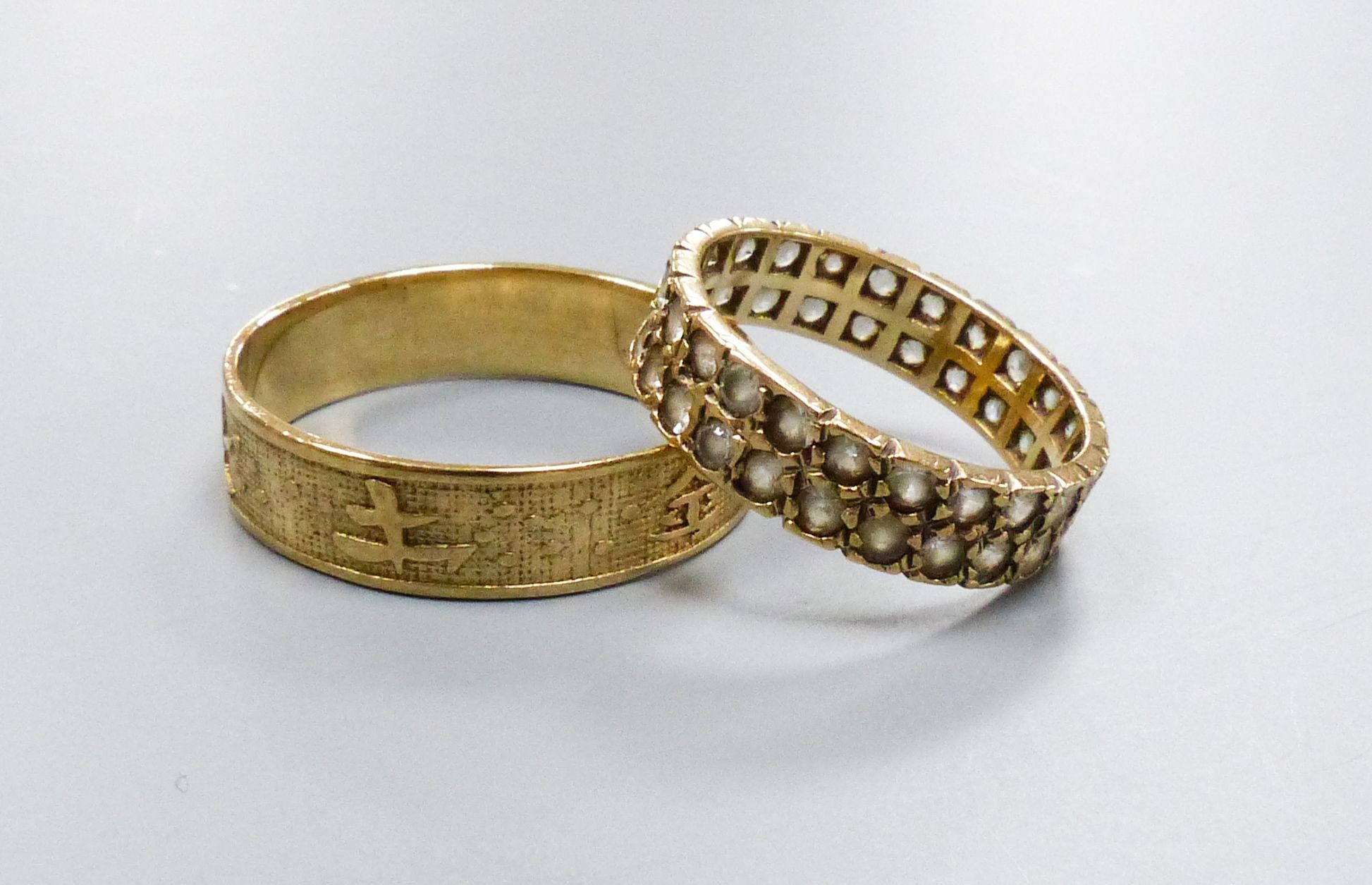 A Chinese yellow metal ring, size X, 3.1 grams and a paste-set 9ct gold ring, gross 2.6 grams.